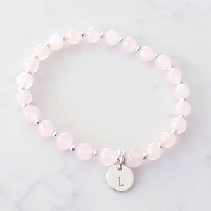 6mm rose quartz bracelet with a personalised disc charm, and silver beads between each gemstone